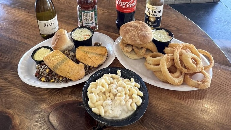 Variety of fish dishes with mac and cheese and drink options