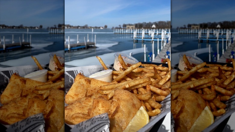 basket of fish and fries with the bay in the background