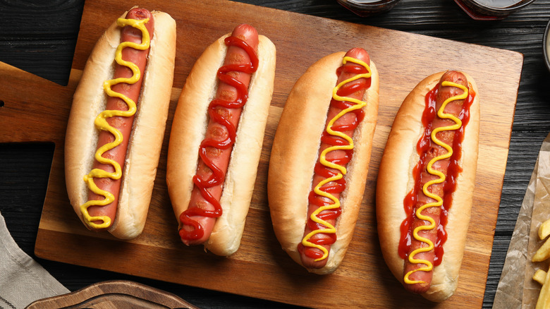 Hot dogs on wooden board