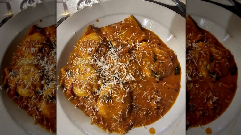 bowl of lobster ravioli topped with grated cheese