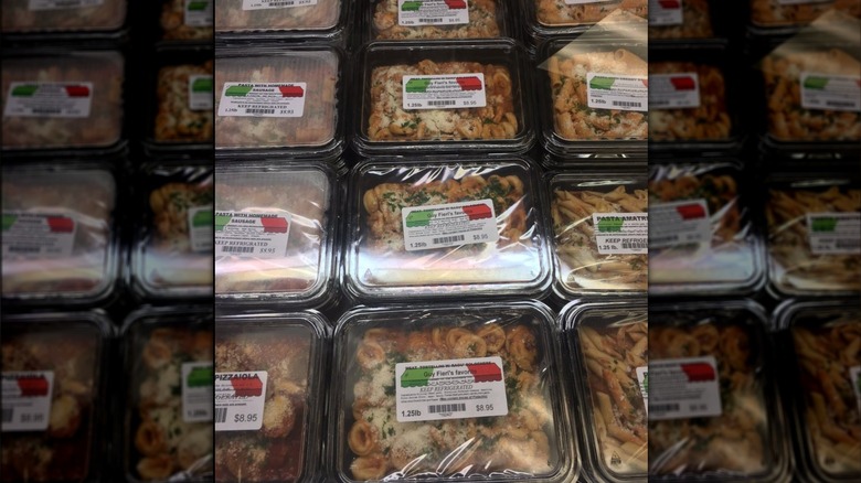pre-packed pasta meals in plastic containers including tortellini bolognese