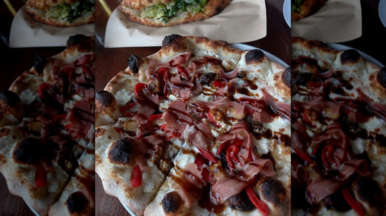 overhead shot of a pizza topped with prosciutto and balsamic glaze