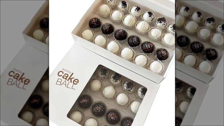 Gift box full of assorted cake ball desserts.