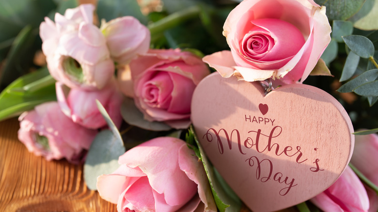 Bouquet of pink flowers with heart-shaped sign reading, 