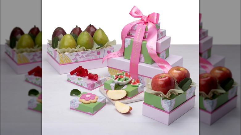 Gift assortment with pears, apples, cookies, and candy.