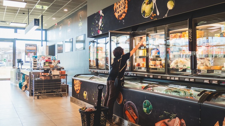 Shopper reaching for frozen item in Aldi.