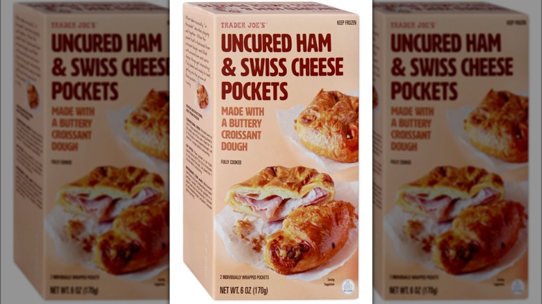 Box of frozen Trader Joe's Uncured Ham & Swiss Cheese Pockets against white background.