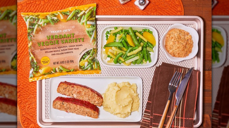 Table Spread with a tray, food, utensils, and bag of Trader Joe's Verdant Veggie Variety.