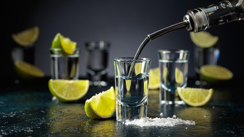 pouring tequila shots with lime