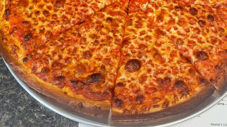 A close-up of Monte's cheese pizza on steel platter
