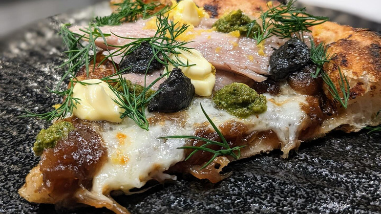 pizza with tuna and seasoning on top