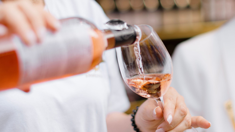 Pouring glass of rose wine.