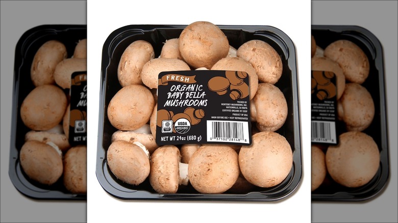 Container of organic baby bella mushrooms.