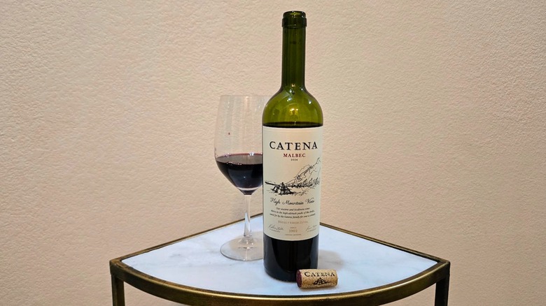 Bottle of Catena Malbec next to its cork and a wine glass