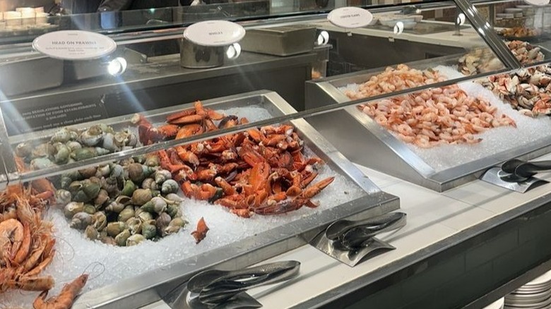 Prawns, lobster, and shrimp laid out at a seafood buffet