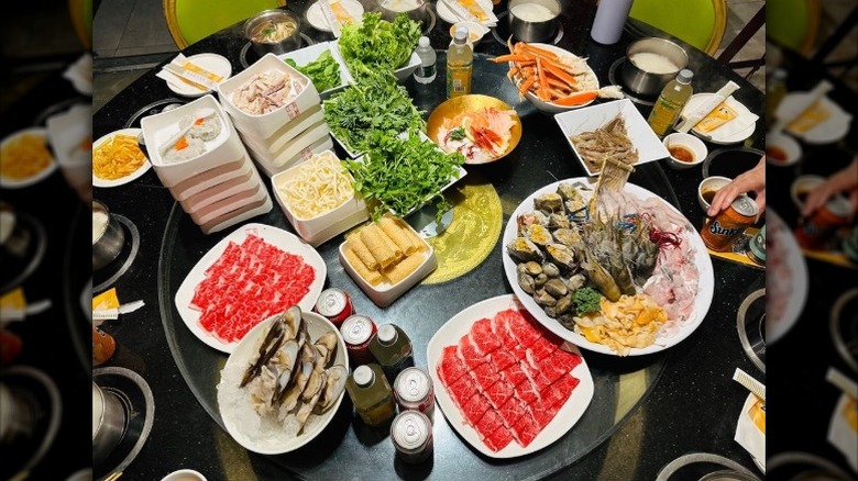 A full table at a seafood hot pot all-you-can-eat buffet