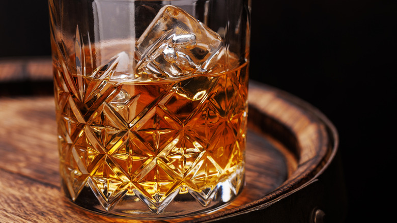 Glass of whiskey on a barrel