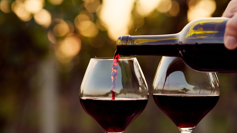 Pouring glasses of red wine
