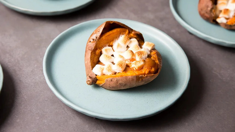 loaded sweet potato on a blue plate