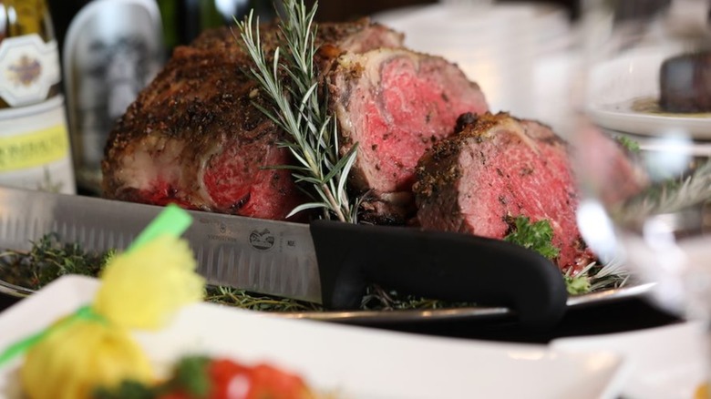 Shanahan's prime rib roast with knife and rosemary