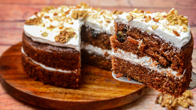 Carrot cake being cut into