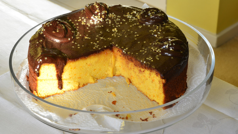 Yellow cake with chocolate icing in a glass dish