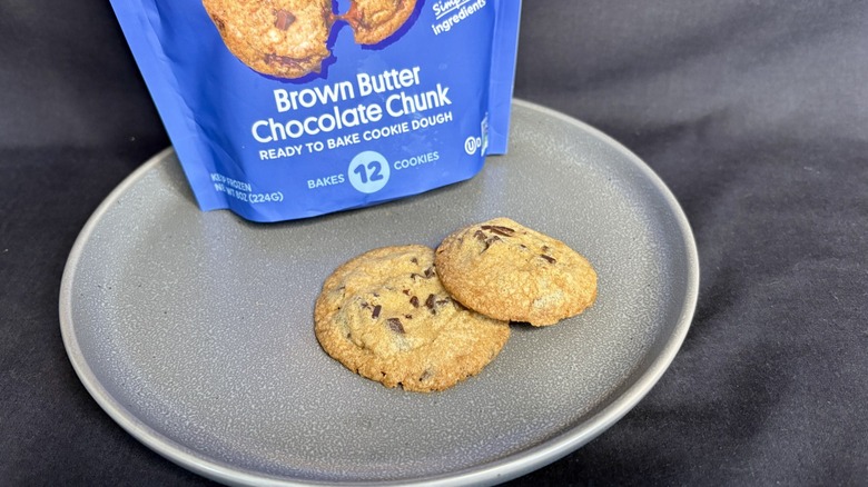 two cookies on plate in front of blue package