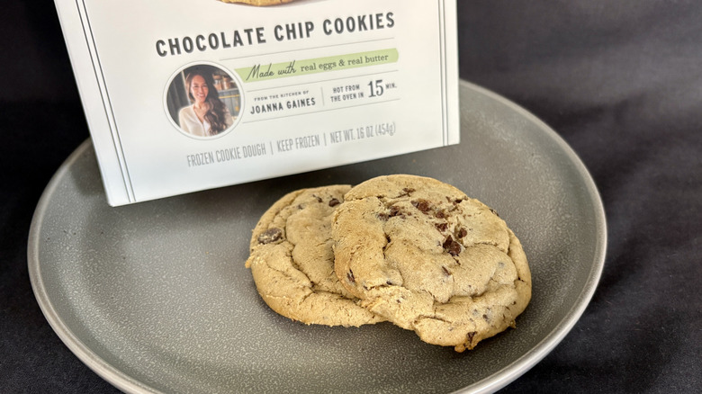 two cookies on plate in front of white package
