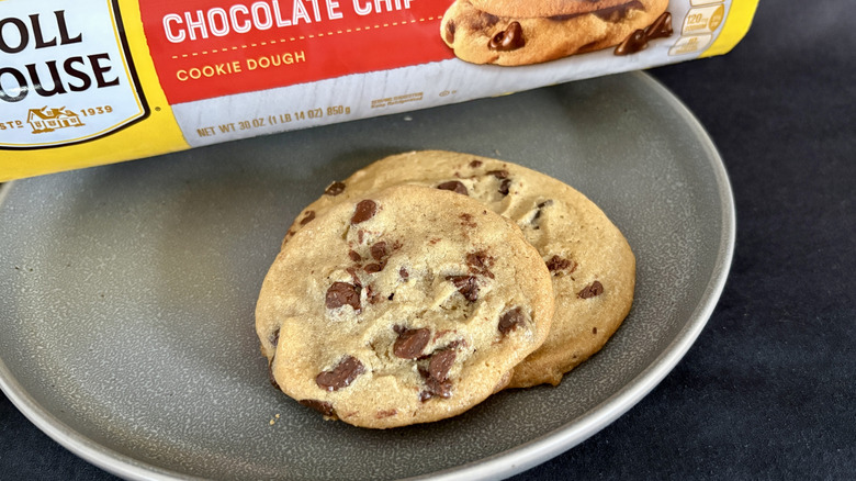 two cookies on plate in front of yellow and red package