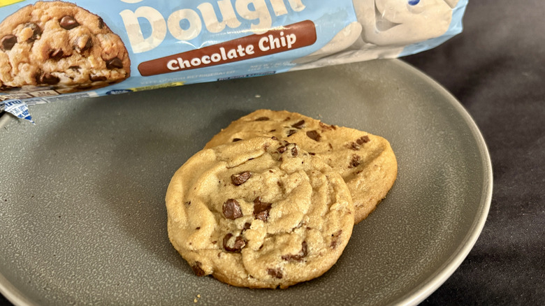 two cookies on plate in front of blue package