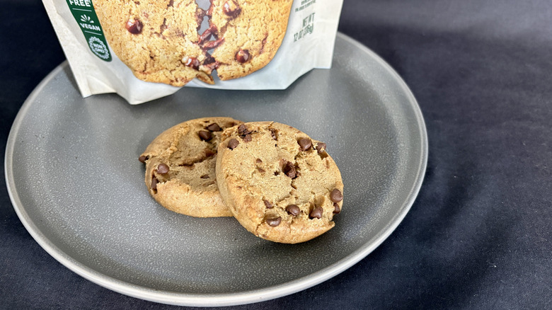 two cookies on plate in front of white package