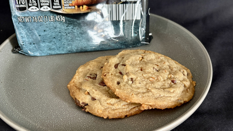 two cookies on plate in front of blue and black package