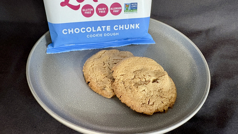 two cookies on plate in front of white and blue package