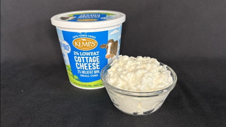 Tub of Kemps 2% lowfat cottage cheese next to a bowl of the cottage cheese