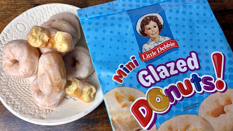 A bag of Little Debbie Mini Glazed Donuts next to a plate of the mini glazed donuts