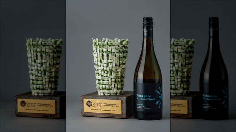 Bottle of Barons Edmond de Rothschild Rimapere Sauvignon Blanc next to trophy