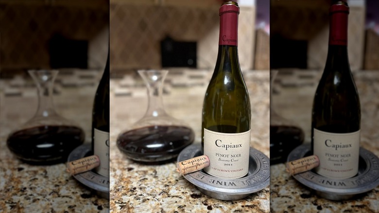 Bottle of Capiaux Chimera Pinot Noir with cork and decanter
