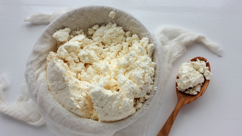 Fresh cheese in cheesecloth with spoon