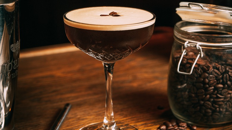 Martini sitting beside coffee beans 