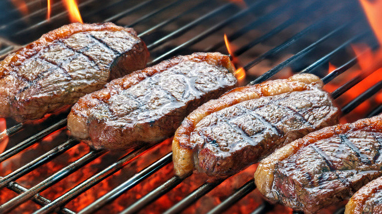 sliced picanha cooking on a grill at a steakhouse