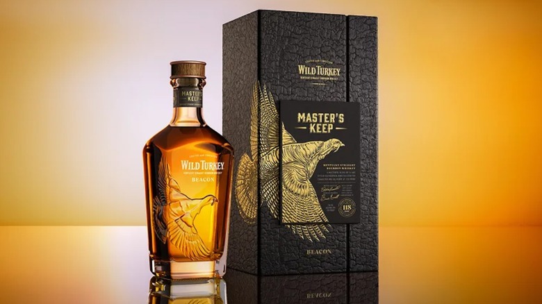 Bottle of Wild Turkey Master's Keep Beacon with fancy box on gold background