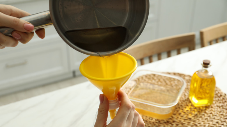 Pouring oil in container
