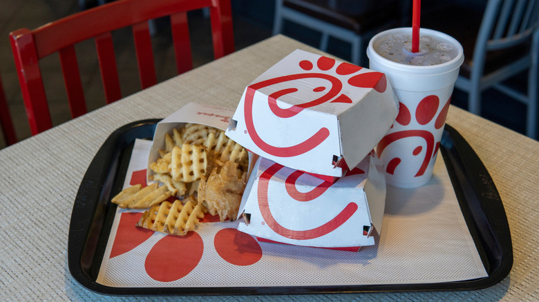 Sandwiches, fries, and beverage on tray at Chick-fil-A restaurant.