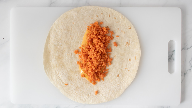 flour tortilla with cheese sauce and rice