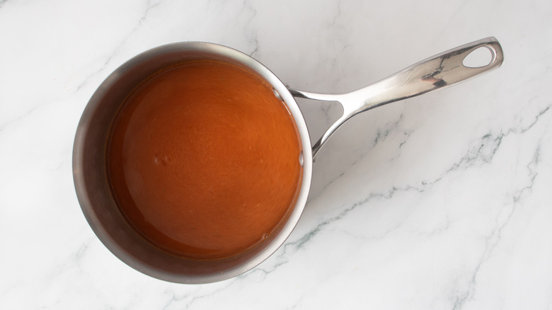 brownish-red liquid in a metal pot