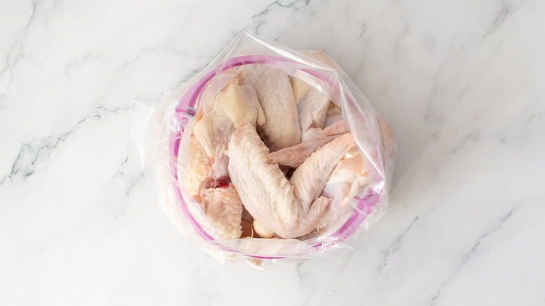 Raw chicken wings in zip-top bag