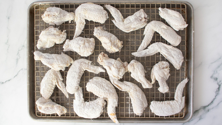 Flour-coated wings on wire rack