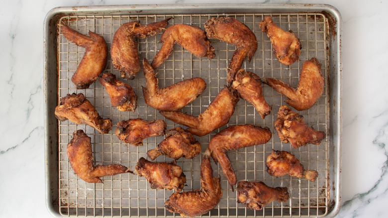 Fried chicken wings on wire rack