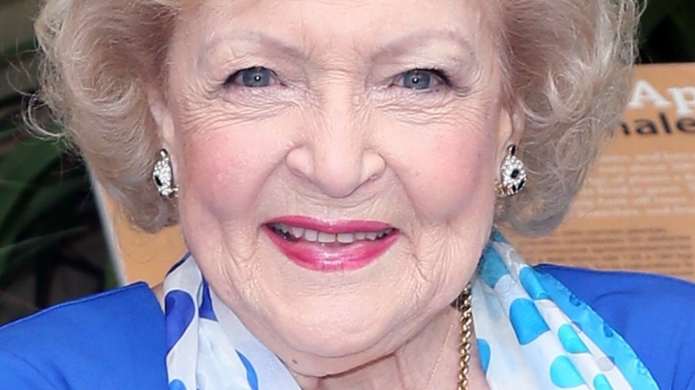 Betty White smiling and wearing blue