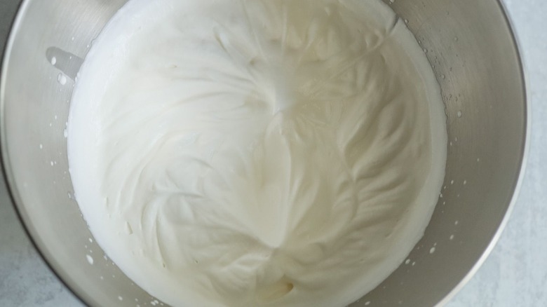 Whipped cream in mixer bowl
